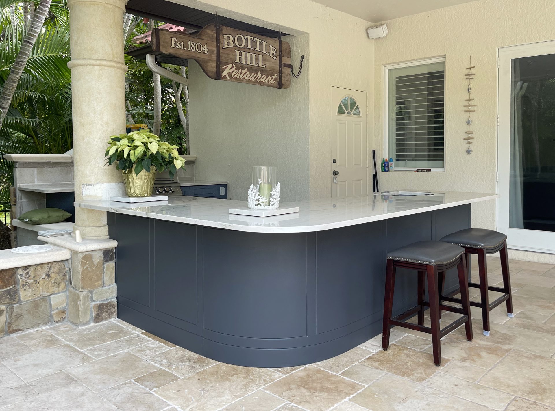 OUTDOOR KITCHEN 29. Custom outdoor kitchen in Casey Key, FL. Kitchen features charcoal grey, sport style cabinets. Appliances include Blaze grill and stainless bar pulls.